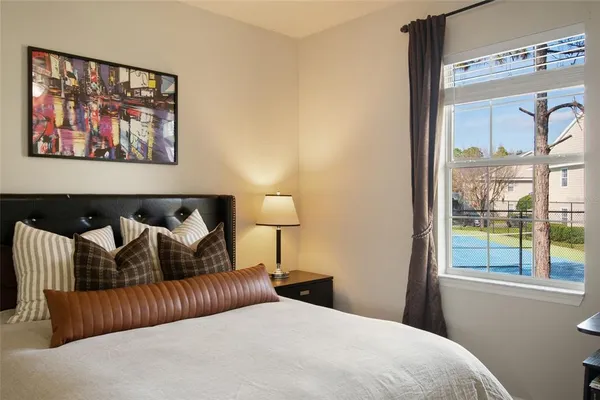 a bedroom with a bed and a painting on the wall