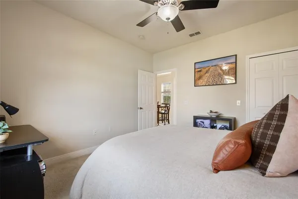 a bedroom with a bed and ceiling fan