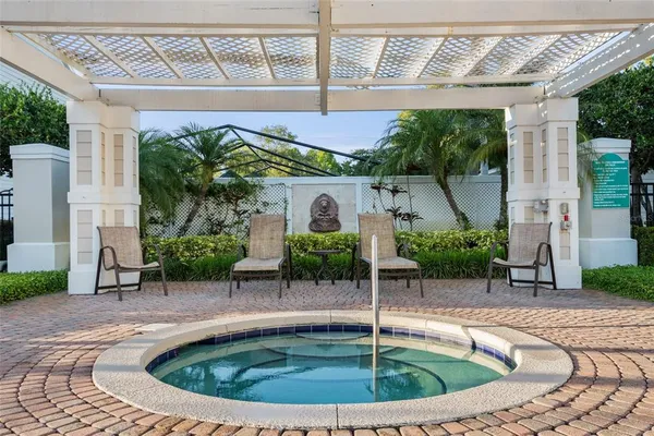 a view of a house with backyard sitting area and swimming pool