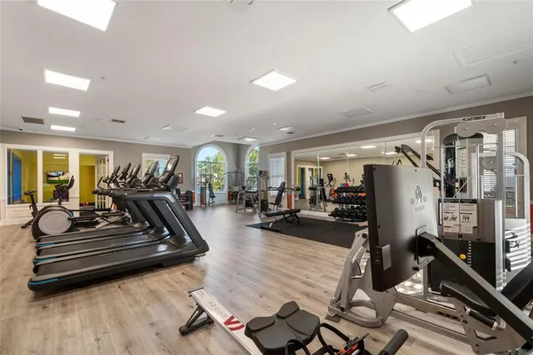 a living room with lots of furniture and gym equipment