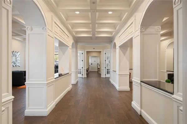 a view of a hallway with wooden floor and staircase