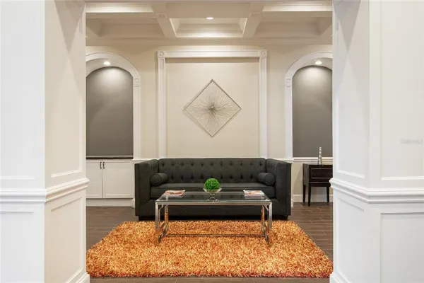 a living room with furniture and a mirror