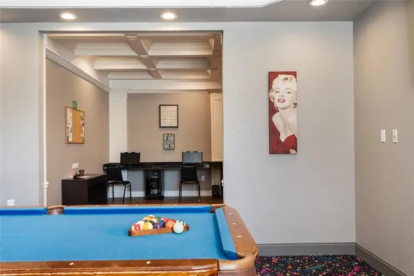 a room with furniture and pool table