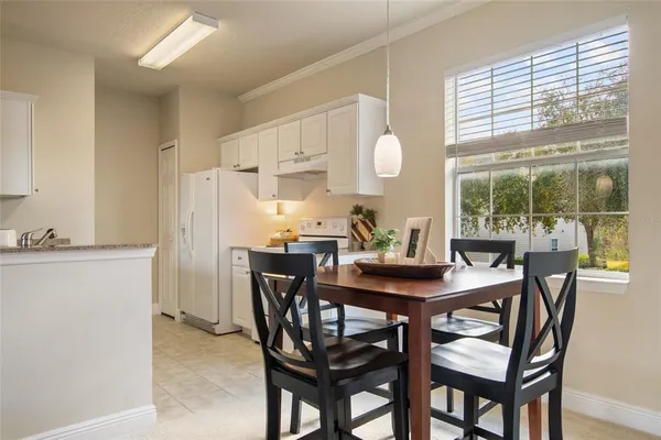 a view of a dining room with furniture and window