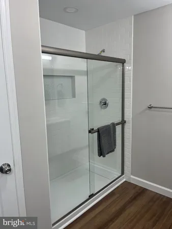 a bathroom with a glass shower door