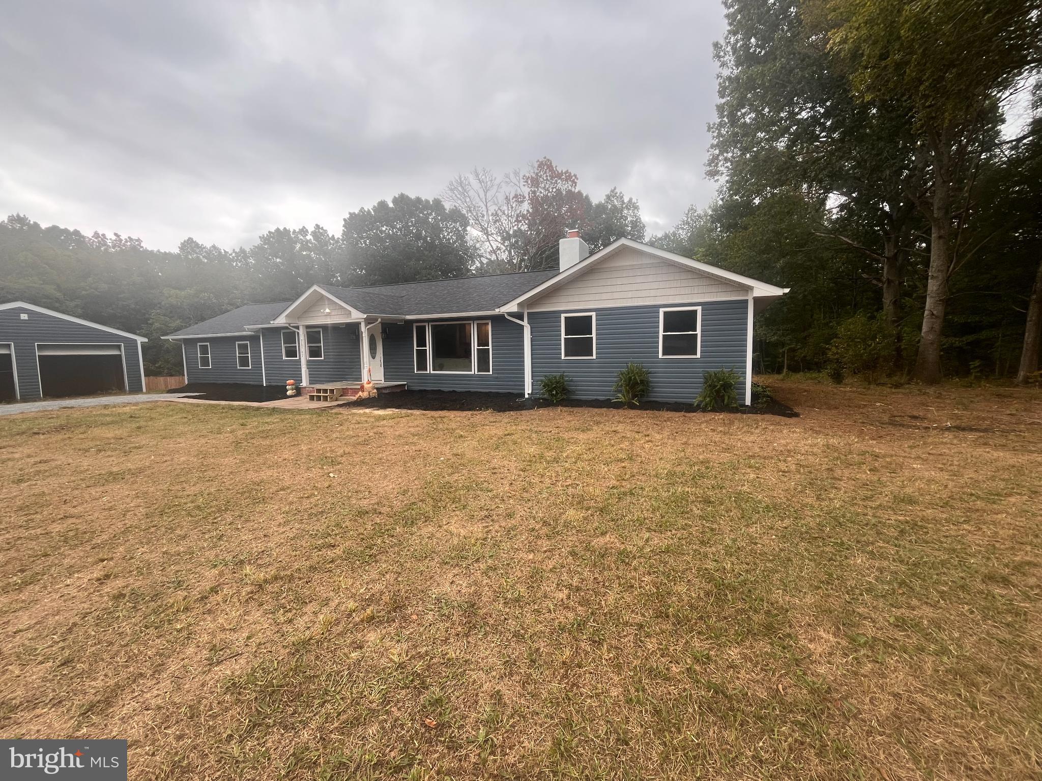 28542 Raccoon Ford Road Burr Hill, VA 22433 - Photo 4 of 31 a front view of a house with a yard and trees