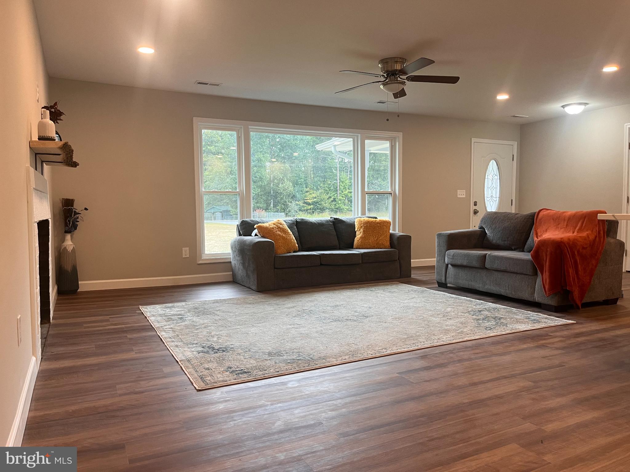 28542 Raccoon Ford Road Burr Hill, VA 22433 - Photo 10 of 31 a living room with furniture and a wooden floor
