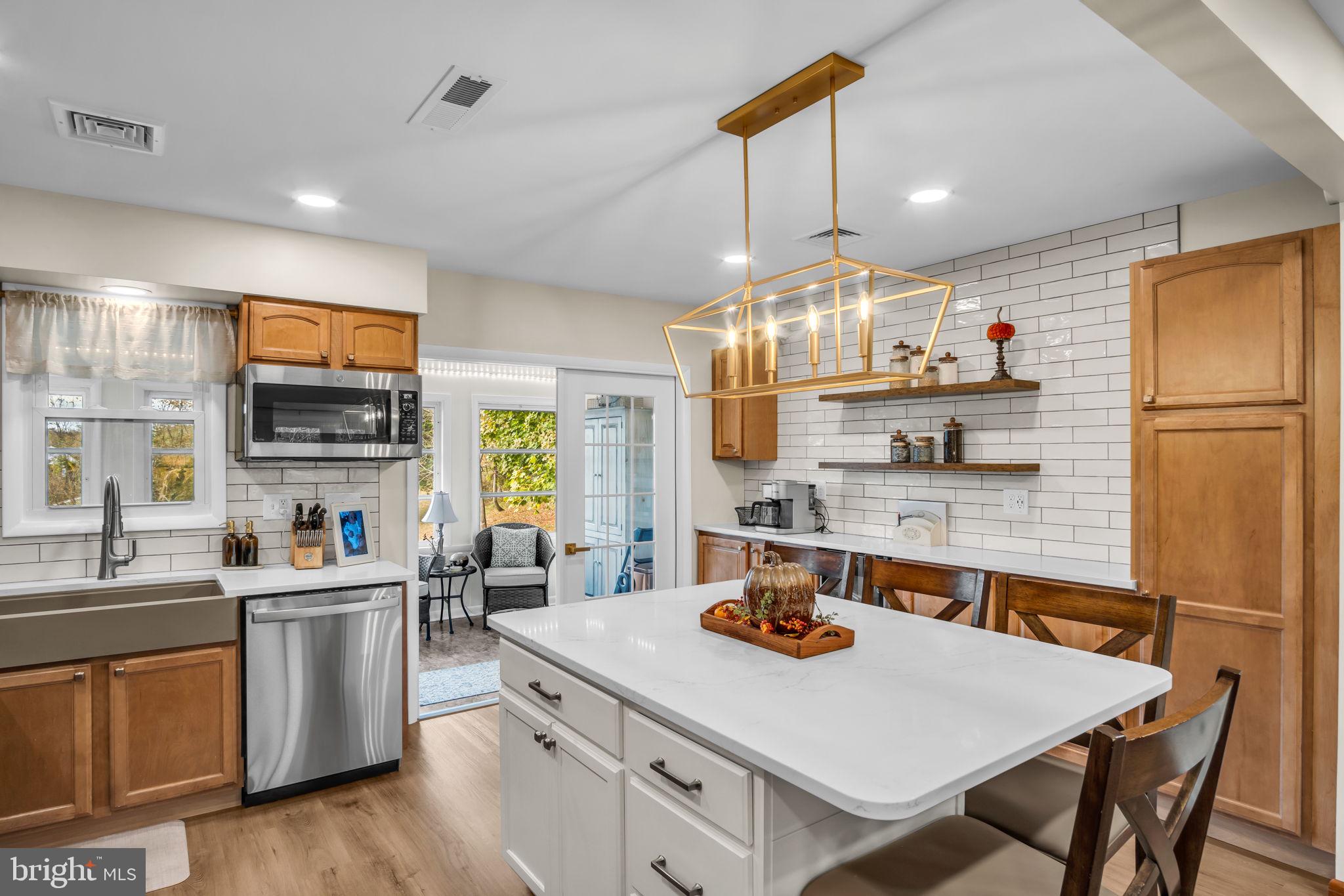 23 Roseglen Road Duncannon, PA 17020 - Photo 4 of 27 a kitchen with stainless steel appliances a stove a sink a refrigerator a center island and chairs