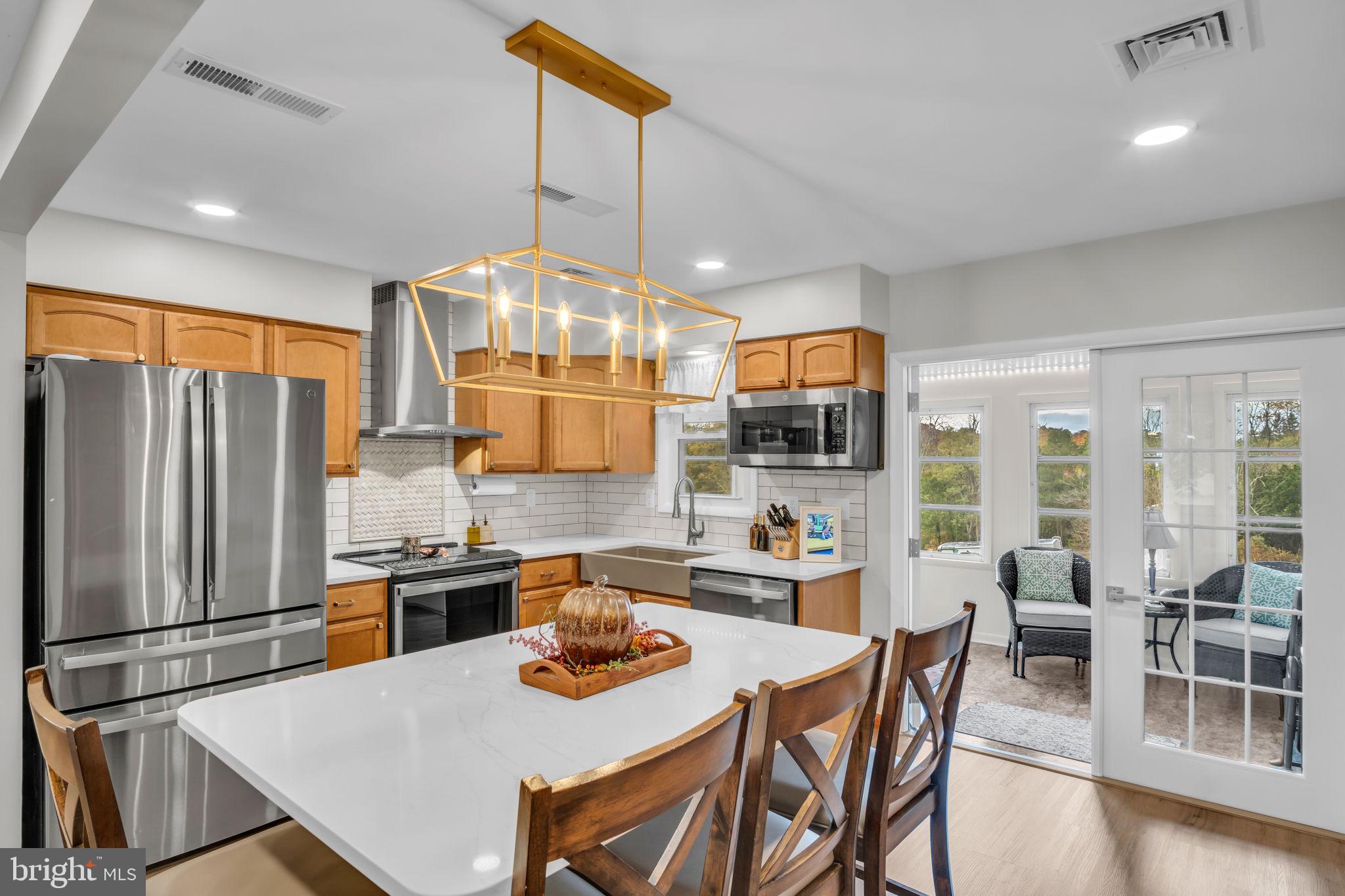 23 Roseglen Road Duncannon, PA 17020 - Photo 5 of 27 a kitchen with stainless steel appliances granite countertop a sink a stove a refrigerator cabinets and chairs
