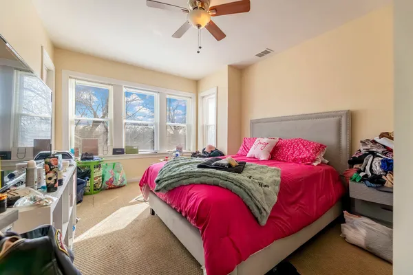 a bedroom with a bed and a chandelier