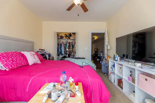 a bedroom with a bed and a flat screen tv