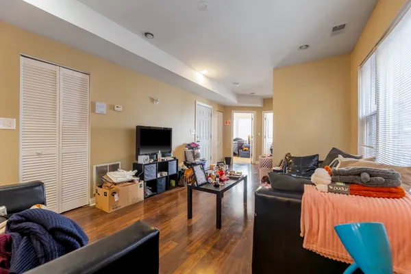 a living room with furniture wooden floor and a flat screen tv
