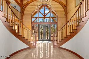 a dining hall with stainless steel appliances granite countertop a stove and cabinets with wooden floor