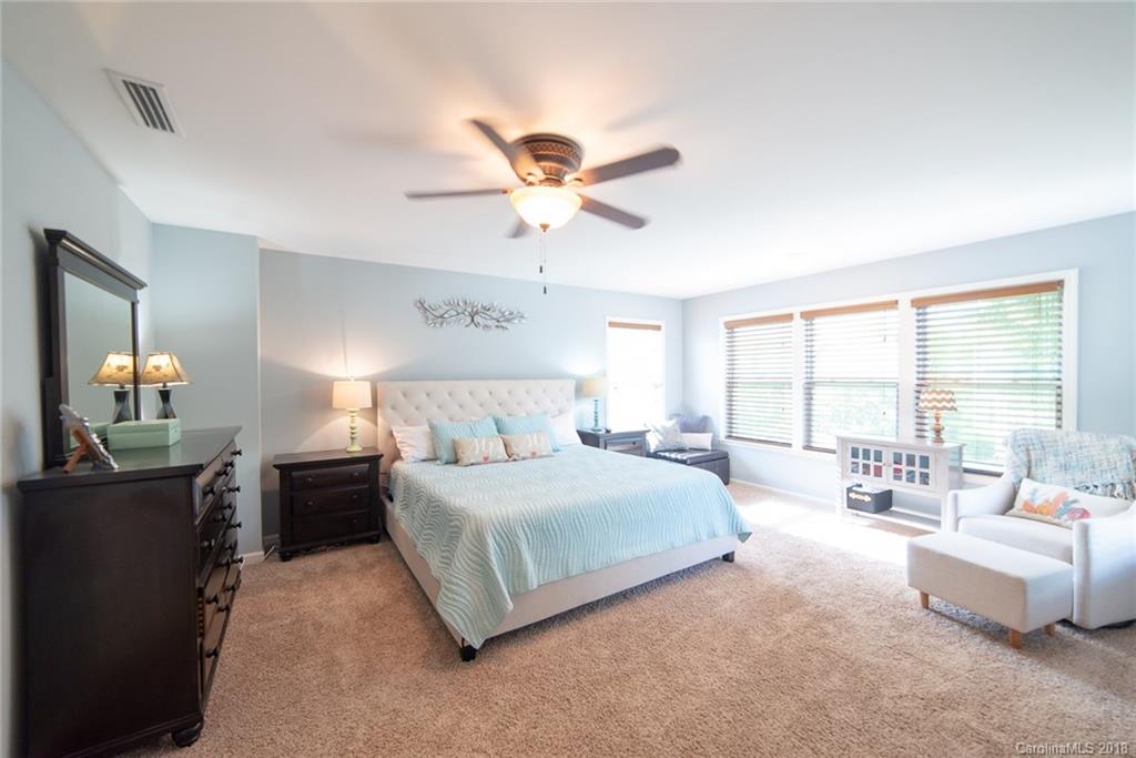 7196 Meyer Road Fort Mill, SC 29715 - Photo 22 of 31 a spacious bedroom with a bed and a couch