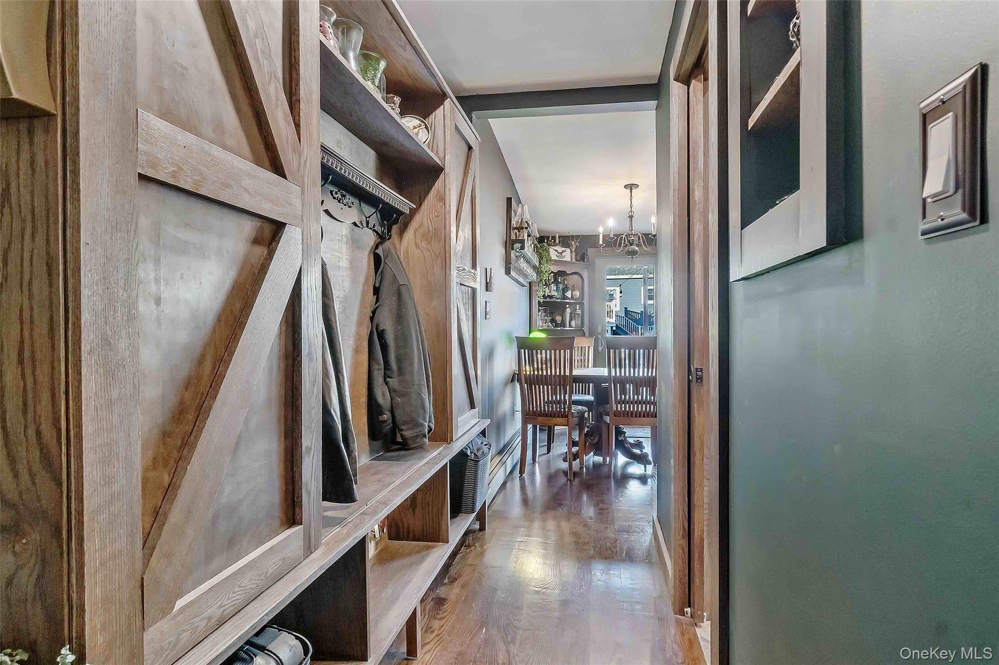 27 West 11th Road Queens, NY 11693 - Photo 6 of 18 Mudroom with wood finished floors and a chandelier