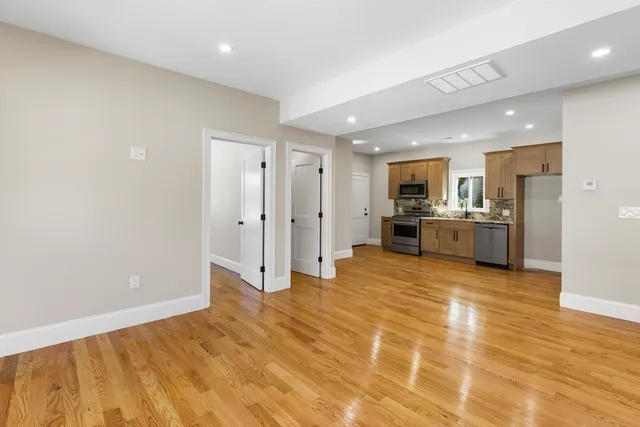 a view of a kitchen with a sink and a refrigerator