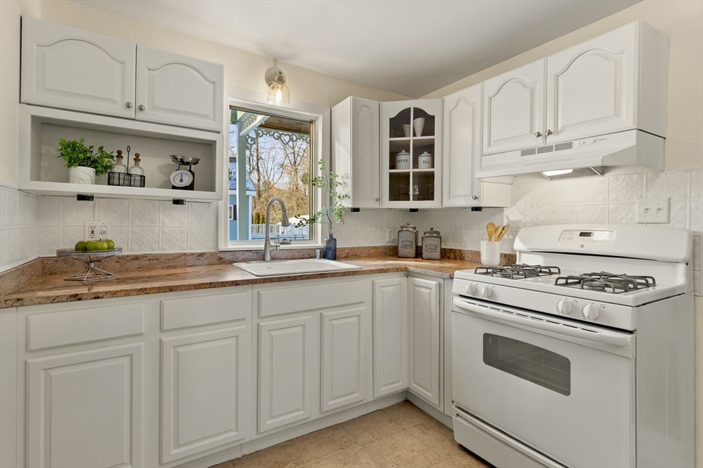 9 Summer Street Billerica, MA 01821 - Photo 16 of 40 a kitchen with granite countertop white cabinets and white appliances