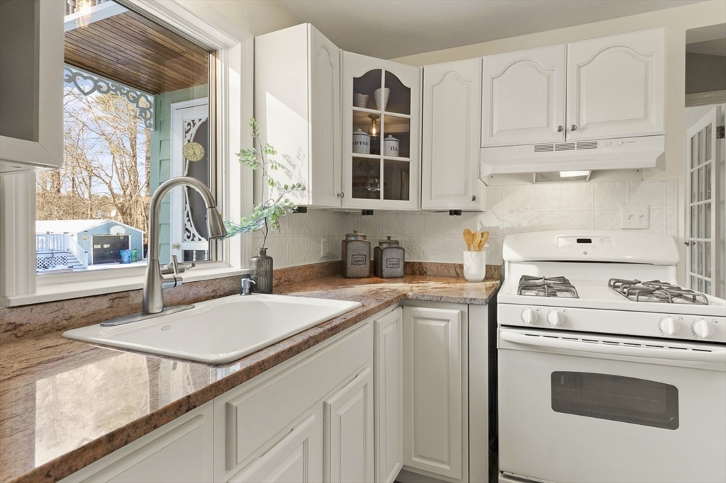 9 Summer Street Billerica, MA 01821 - Photo 17 of 40 a kitchen with a stove a sink and a microwave