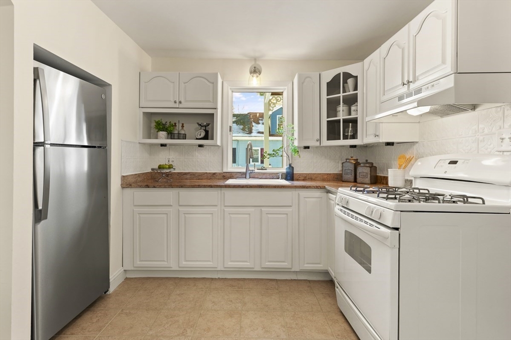 9 Summer Street Billerica, MA 01821 - Photo 18 of 40 a kitchen with white cabinets and white appliances