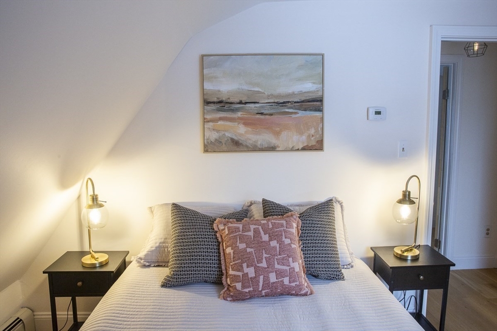 9 Summer Street Billerica, MA 01821 - Photo 29 of 40 a bedroom with furniture and a wooden floor