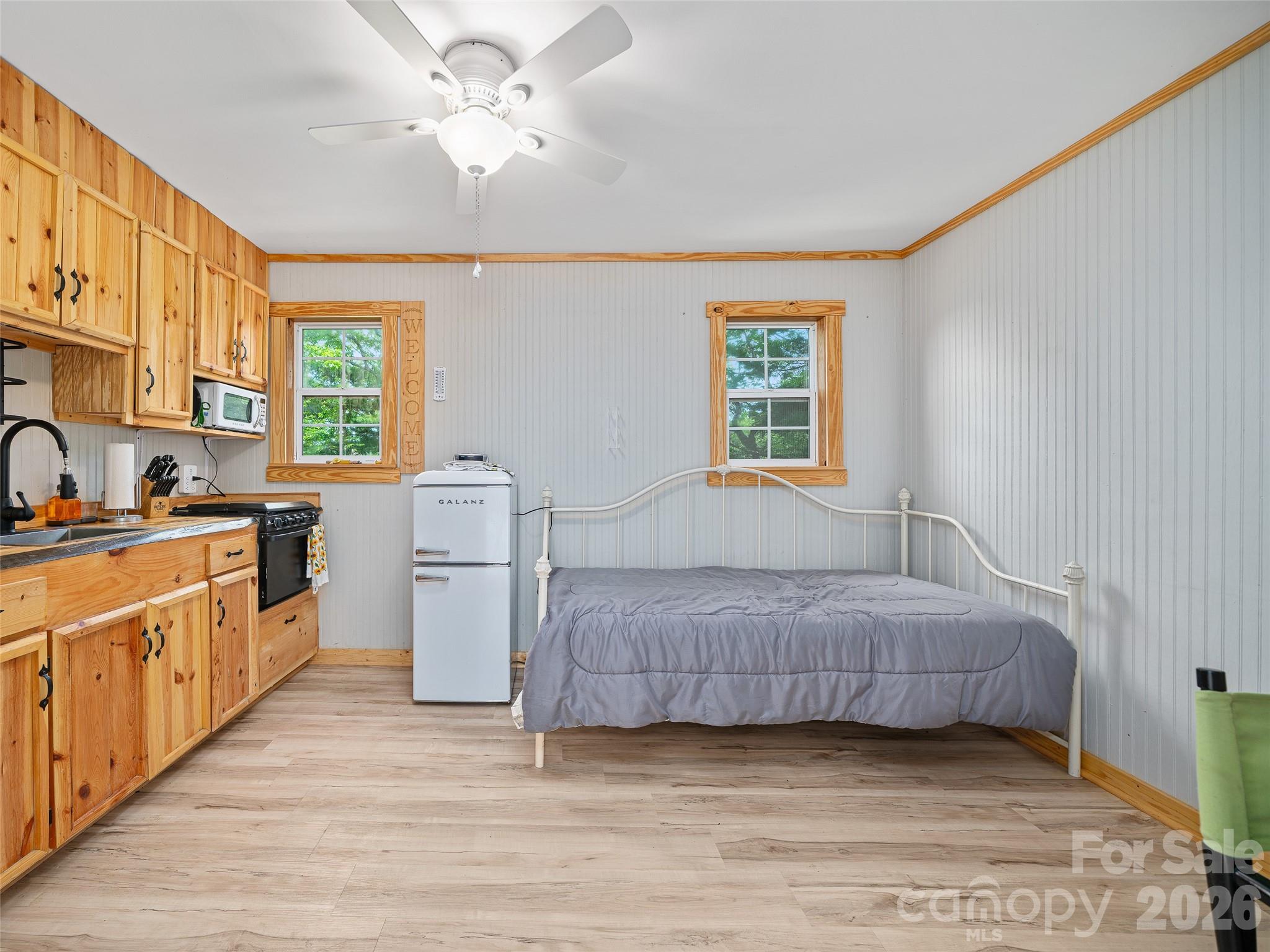 228 Continental Divide Road Spruce Pine, NC 28777 - Photo 38 of 48 a room with a bed and a chandelier