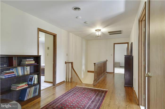 14900 Mount Nebo Road Poolesville, MD 20837 - Photo 13 of 30 a view of a hallway with furniture and wooden floor