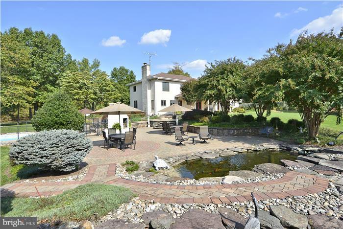 14900 Mount Nebo Road Poolesville, MD 20837 - Photo 22 of 30 a view of a patio with table and chairs and potted plants