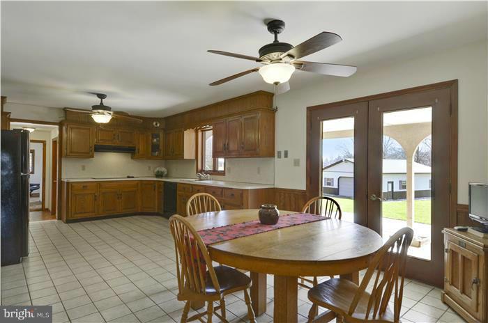 14900 Mount Nebo Road Poolesville, MD 20837 - Photo 6 of 30 a dining room with stainless steel appliances a table and chairs