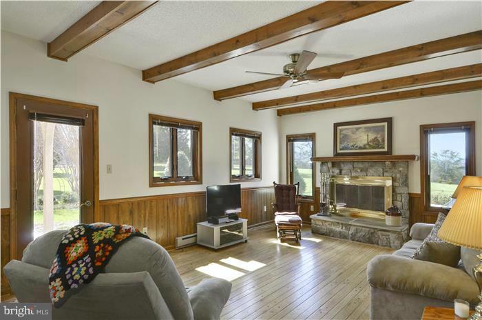14900 Mount Nebo Road Poolesville, MD 20837 - Photo 7 of 30 a living room with furniture and a fireplace