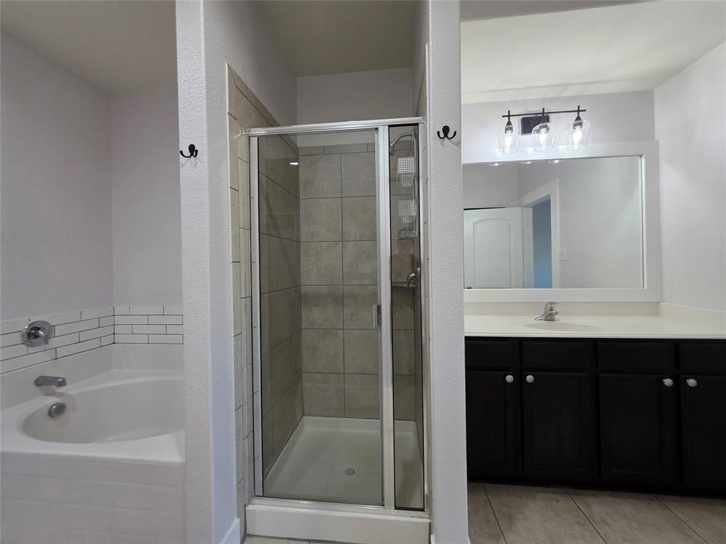 149 Ryan Street Anna, TX 75409 - Photo 18 of 38 a bathroom with a bathtub and a sink