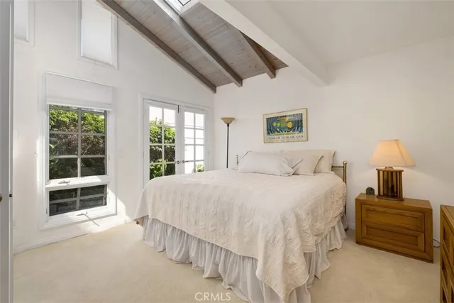 a spacious bedroom with a bed and a window