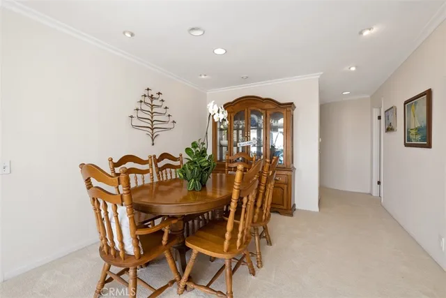 a view of a dining room with furniture and a potted plant