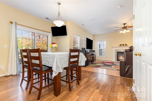 a dining room with furniture a chandelier and wooden floor