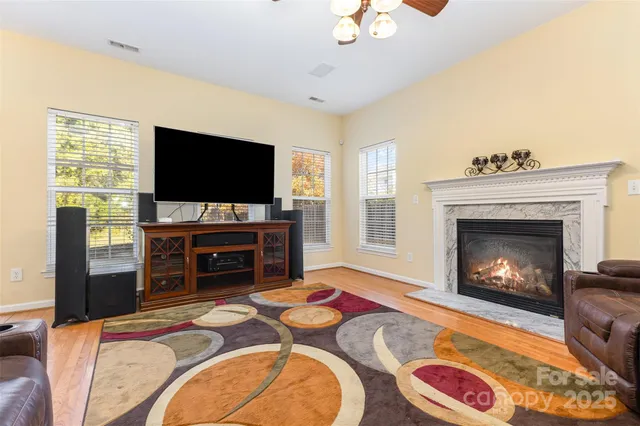 a living room with fireplace furniture and a flat screen tv