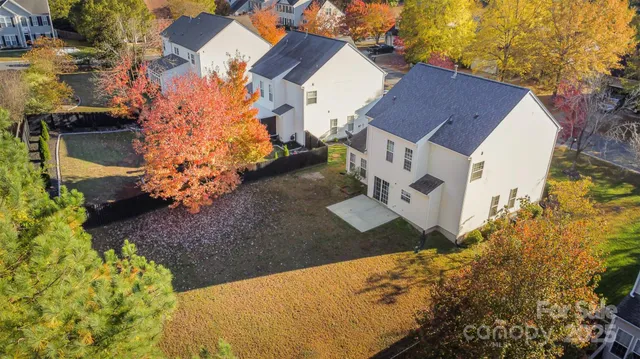 a aerial view of a house with a yard and garden