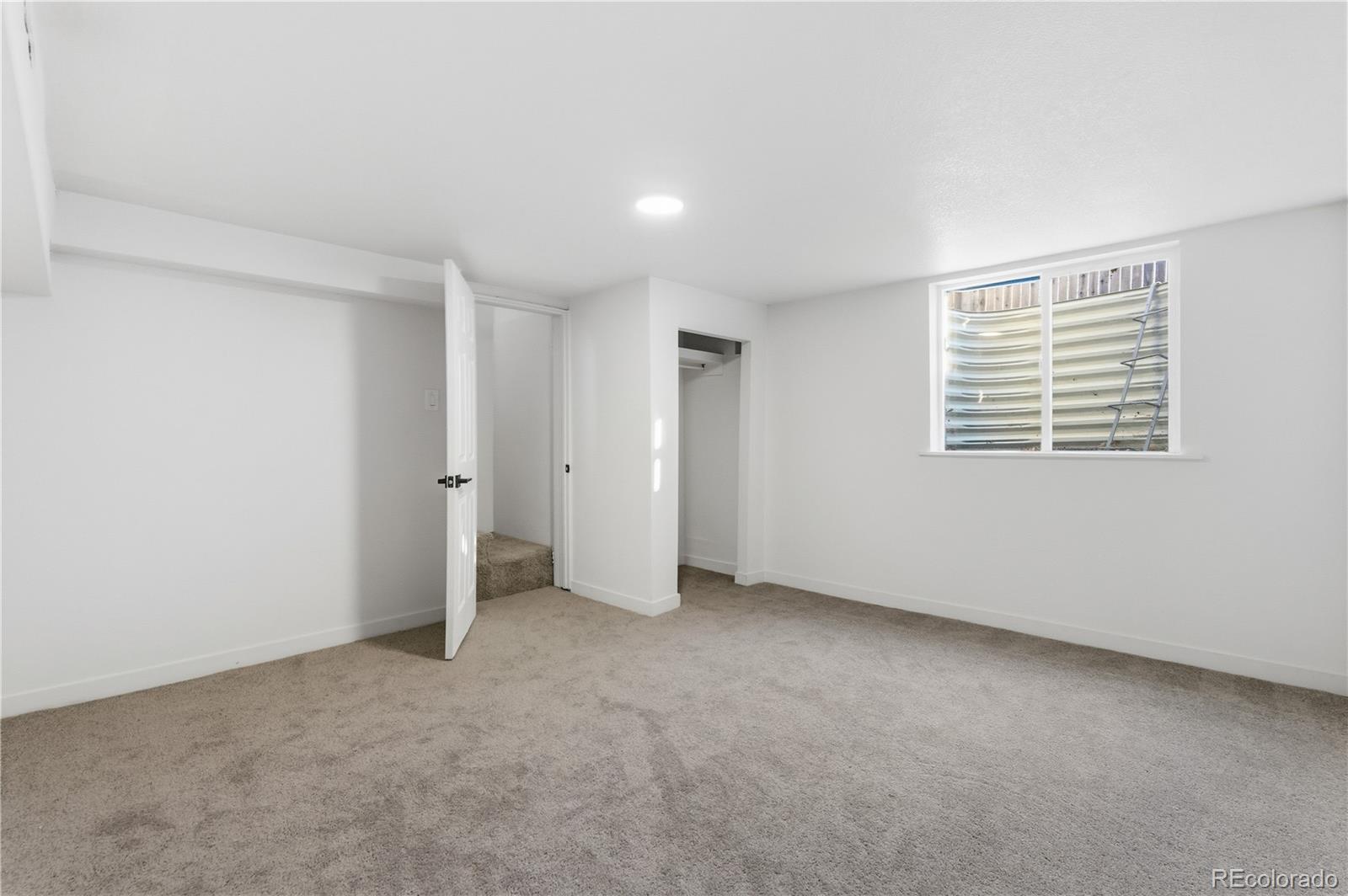 1550 South Xavier Street Denver, CO 80219 - Photo 15 of 46 a view of an empty room with a window