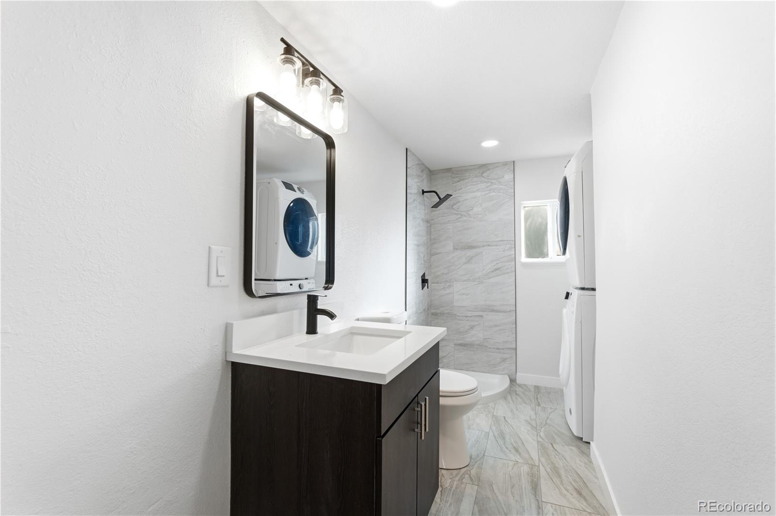 1550 South Xavier Street Denver, CO 80219 - Photo 20 of 46 a bathroom with a sink and a mirror