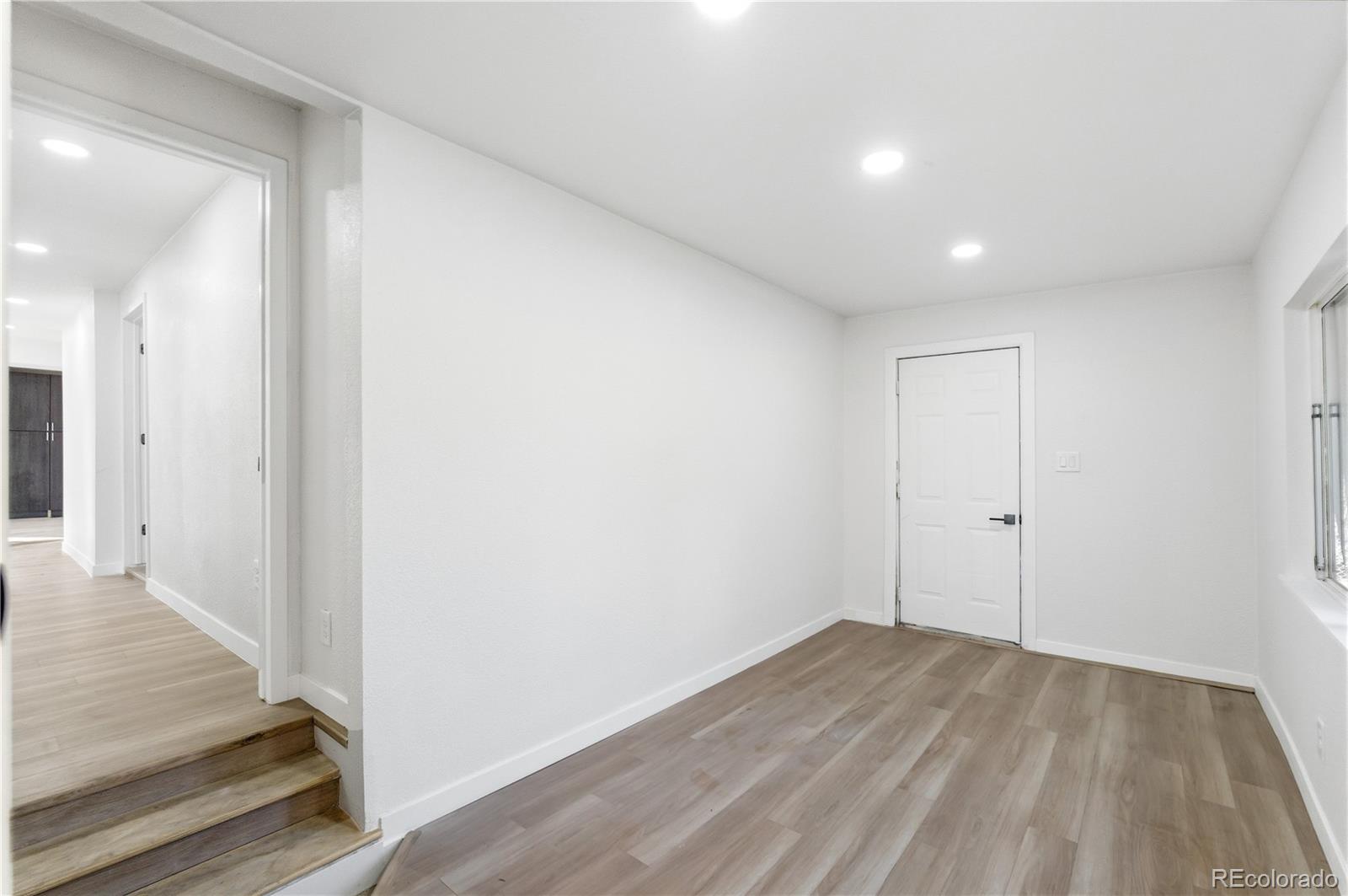 1550 South Xavier Street Denver, CO 80219 - Photo 21 of 46 a view of a hallway with wooden floor
