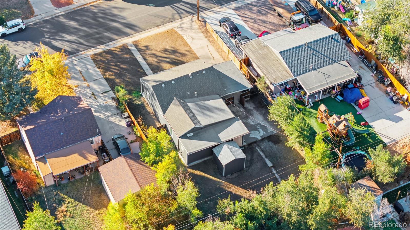 1550 South Xavier Street Denver, CO 80219 - Photo 32 of 46 an aerial view of a house with swimming pool and large trees