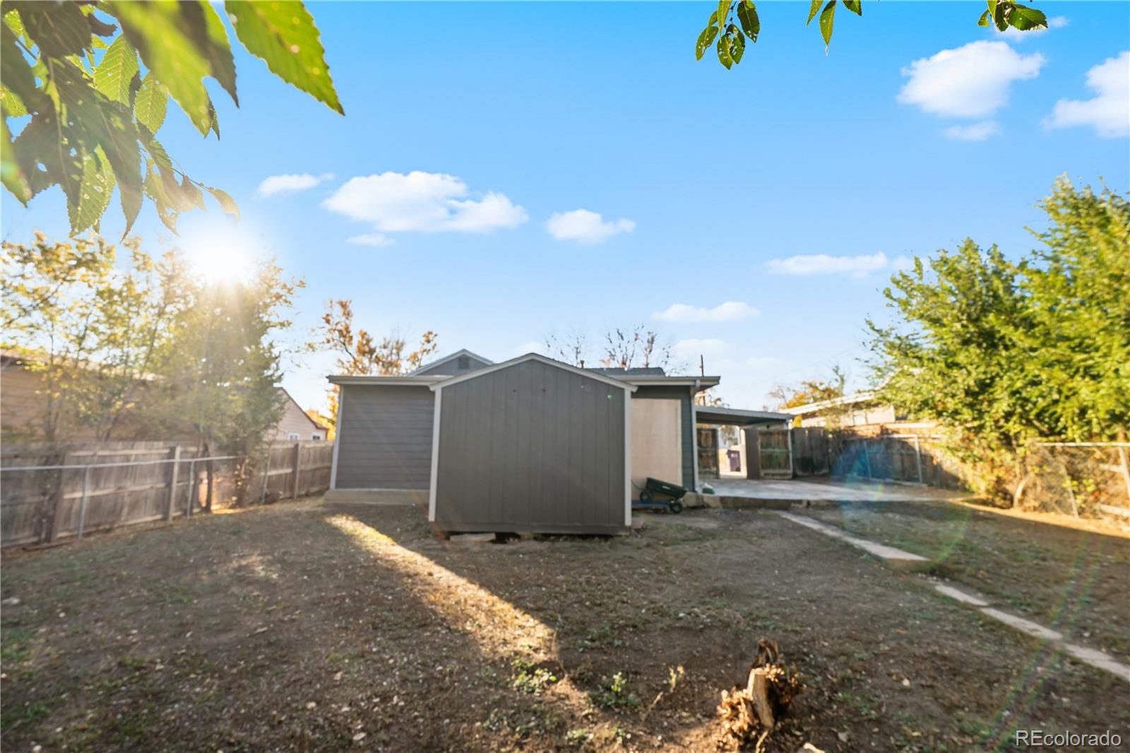 1550 South Xavier Street Denver, CO 80219 - Photo 41 of 46 a view of a house with a yard and a garage