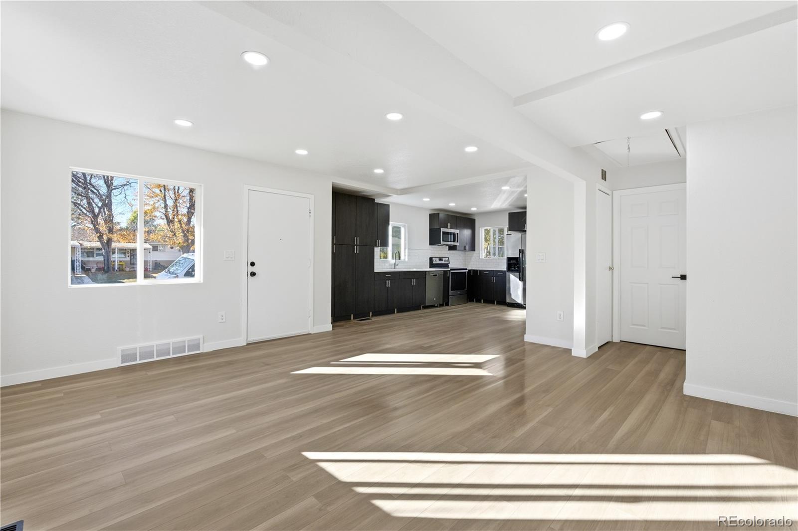 1550 South Xavier Street Denver, CO 80219 - Photo 5 of 46 a view of kitchen with cabinets and wooden floor
