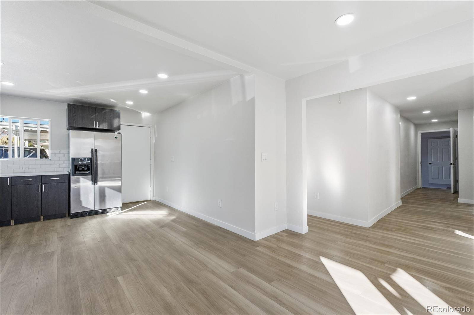 1550 South Xavier Street Denver, CO 80219 - Photo 10 of 46 a view of a kitchen with a sink and a refrigerator