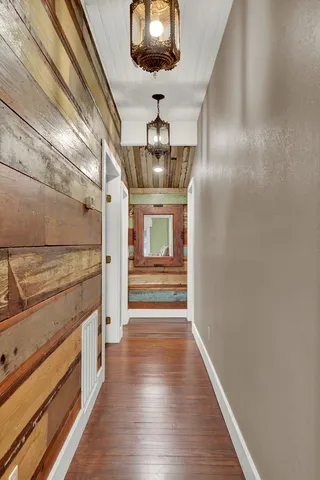 a view of entryway and hall with wooden floor