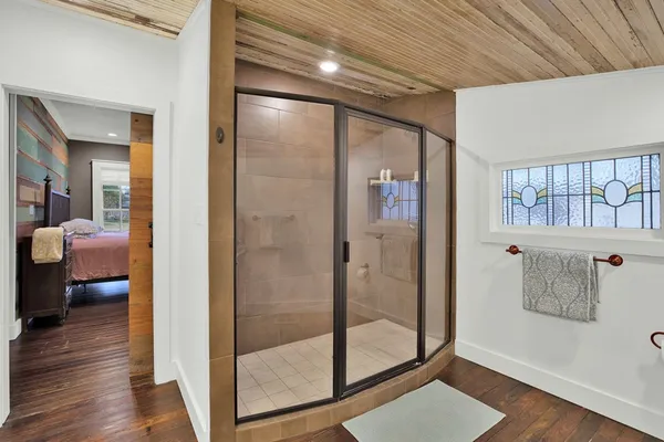 a bathroom with a glass shower door