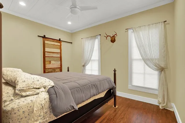 a bedroom with a bed and a window