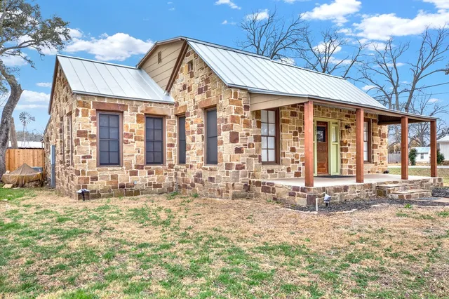 a view of a brick house with many windows