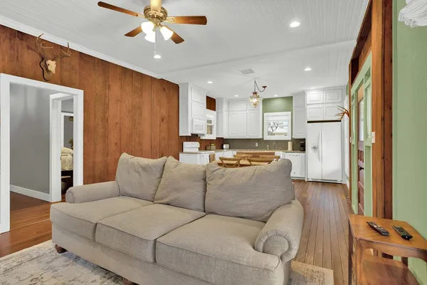 a living room with furniture and a chandelier