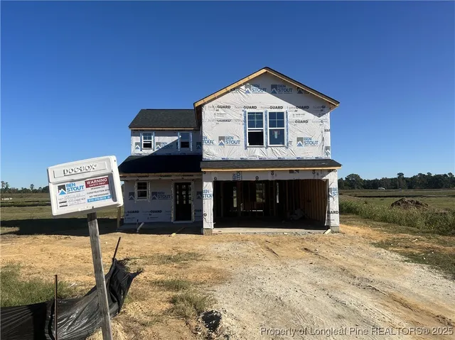 a front view of a house with lake