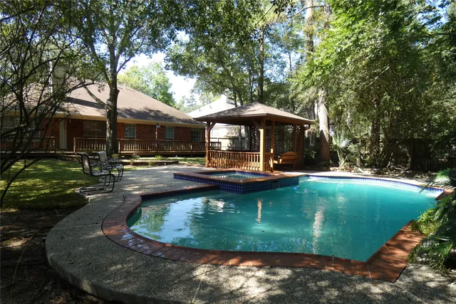 a view of a swimming pool with sitting area