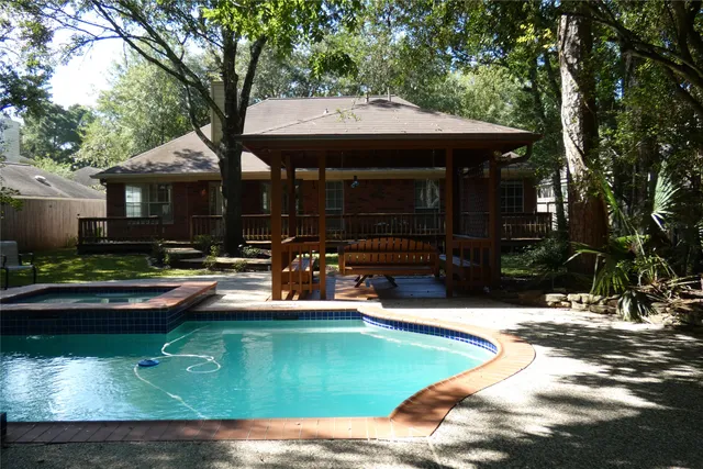 a view of a house with swimming pool and sitting area